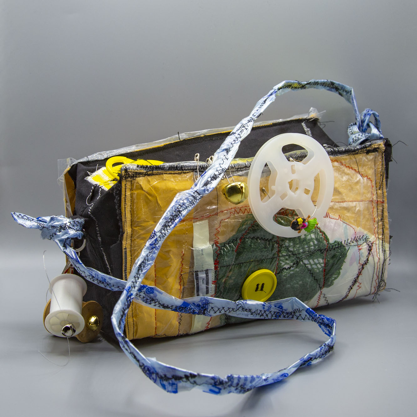 This purse is crafted from discarded materials and shaped like a 3D Dadaist sculpture. It is both functional and durable.